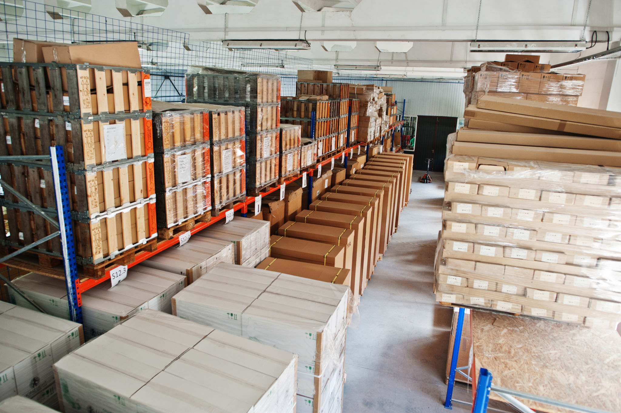 Warehouse with stacked boxes and pallets.